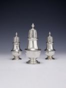 A SET OF THREE GEORGE II SILVER VASE SHAPED CASTERS, PAUL CRESPIN