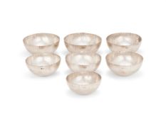 SEVEN SILVER CURVE PATTERN NESTING BOWLS, ADRIAN K. A. HOPE