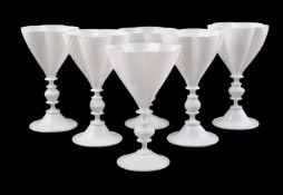A GROUP OF TWENTY FOUR OPAQUE WHITE CASED CLEAR GLASS GOBLETS
