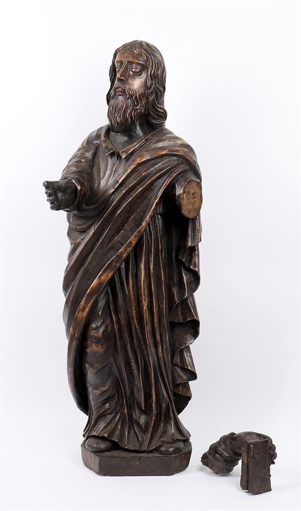 A large stained softwood model of a standing Saint