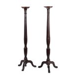 A pair of mahogany torchere stands in George III style