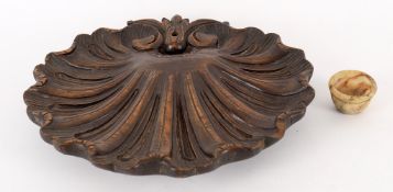 A carved wood shell relief