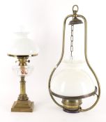 A gilt brass and glass oil lamp