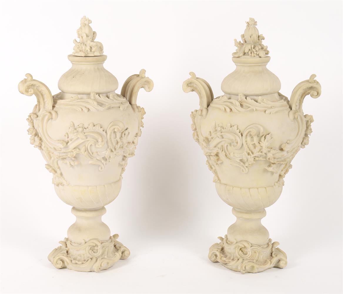A pair of modern resin lidded urns