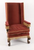 A 17th century style wing back high back armchair