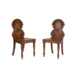 A pair of Victorian oak hall chairs