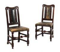 A pair of oak and green leather upholstered side chairs