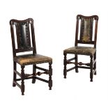 A pair of oak and green leather upholstered side chairs