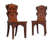 A PAIR OF VICTORIAN CARVED OAK HALL CHAIRS, IN GOTHIC REVIVAL STYLE, MID-19TH CENTURY