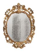 A CARVED GILTWOOD OVAL WALL MIRROR IN GEORGE III STYLE, SECOND QUARTER 19TH CENTURY
