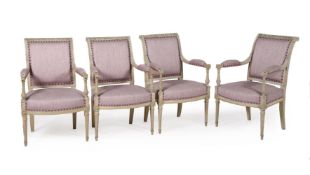 A SET OF FOUR LOUIS XVI CREAM PAINTED AND LILAC UPHOLSTERED ELBOW CHAIRS, LATE 18TH CENTURY
