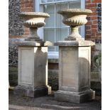 A PAIR OF HADDONSTONE URNS AND PEDESTALS, 20TH CENTURY