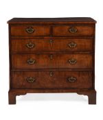 A GEORGE II FIGURED WALNUT, CROSSBANDED AND LINE INLAID CHEST OF DRAWERS, CIRCA 1740