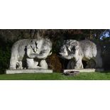 A PAIR OF MONUMENTAL CARVED STONE ELEPHANTS, 20TH CENTURY