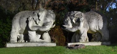 A PAIR OF MONUMENTAL CARVED STONE ELEPHANTS, 20TH CENTURY