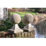 A PAIR OF COMPOSITION STONE BALL PIER FINIALS, 20TH CENTURY