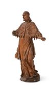 A CARVED LIMEWOOD FIGURE OF A STANDING APOSTOLIC FIGURE SWISS OR SOUTH GERMAN, 17TH CENTURY