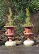 A PAIR OF RED PAINTED CAST IRON GARDEN URNS IN THE FORM OF THE BORGHESE VASE, LATE 19TH CENTURY