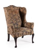 A MAHOGANY AND UPHOLSTERED WING ARMCHAIR, IN GEORGE II STYLE, 19TH CENTURY