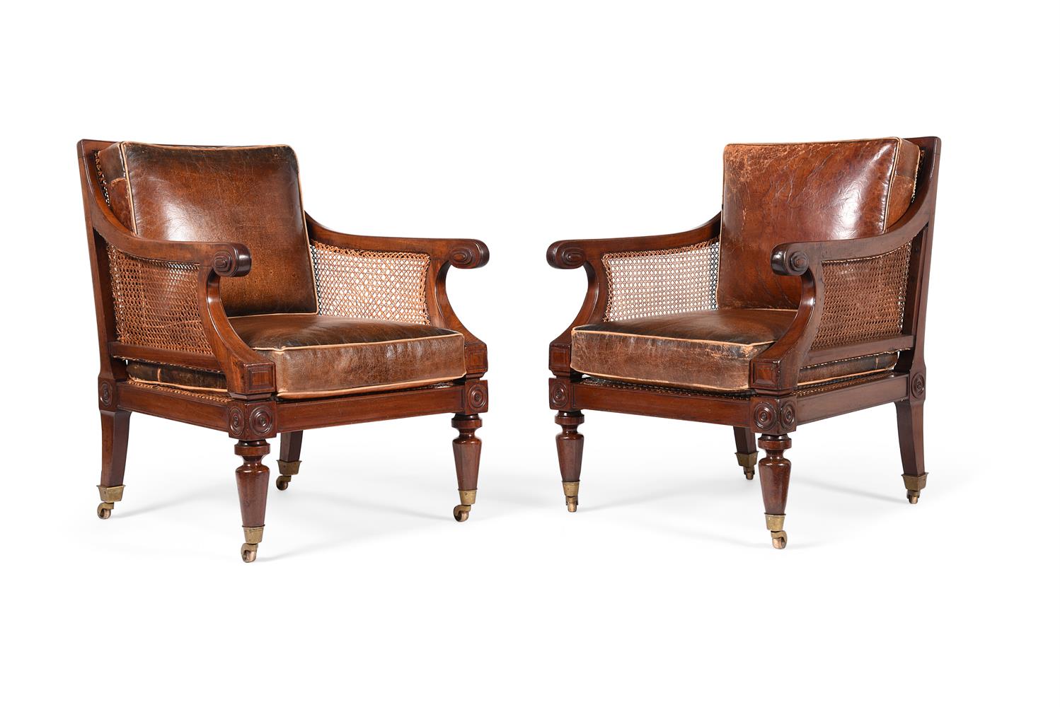 A PAIR OF REGENCY MAHOGANY BERGERE LIBRARY ARMCHAIRS, IN THE MANNER OF CHARLES HEATHCOTE TATHAM