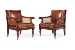 A PAIR OF REGENCY MAHOGANY BERGERE LIBRARY ARMCHAIRS, IN THE MANNER OF CHARLES HEATHCOTE TATHAM