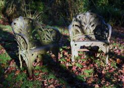 A PAIR OF VICTORIAN CAST IRON GARDEN SEATS IN THE MANNER OF COALBROOKDALE, LATE 19TH CENTURY