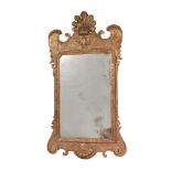 A CARVED GILTWOOD WALL MIRROR, IN GEORGE II STYLE, EARLY 20TH CENTURY