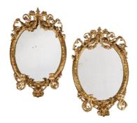 A PAIR OF VICTORIAN GILTWOOD AND COMPOSITION OVAL WALL MIRRORS, SECOND HALF 19TH CENTURY