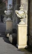 A PAIR OF RECONSTITUTED URNS ON STAND, CONTEMPORARY
