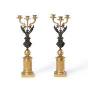 A PAIR OF FRENCH BRONZE AND GILT METAL THREE-LIGHT FIGURAL CANDELABRA IN THE EMPIRE MANNER