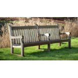 A LARGE WEATHERED HARDWOOD GARDEN BENCH, EARLY/MID 20TH CENTURY
