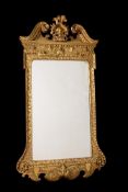 A GEORGE II GILTWOOD AND GESSO WALL MIRROR, IN THE MANNER OF WILLIAM KENT, CIRCA 1740