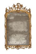 A LOUIS XV CARVED GILTWOOD AND ENGRAVED GLASS WALL MIRROR, CIRCA 1760