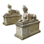 A PAIR OF CAST STONE SPHINXES ON PEDESTAL BASES, 20TH CENTURY AFTER AUSTIN & SEELEY