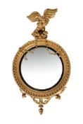 A REGENCY GILTWOOD CONVEX WALL MIRROR, CIRCA 1820