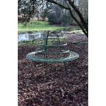 A REGENCY GREEN PAINTED WROUGHT IRON CIRCULAR TREE OR GARDEN SEAT, EARLY 19TH CENTURY