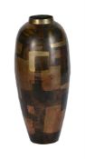 A PATINATED METAL OVOID VASE