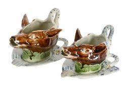 TWO SIMILAR STAFFORDSHIRE PEARLWARE FOX-MASK SWAN-HANDLED SAUCE BOATS AND SWAN STANDS OF PRATT TYPE