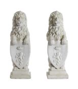 A PAIR OF WHITE PAINTED COMPOSITE STONE MODELS OF HERALDIC LIONS