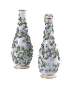 A PAIR OF MEISSEN FLOWER-ENCRUSTED SLENDER BOTTLE VASES AND A COVER
