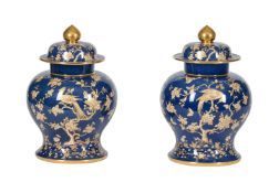A PAIR OF SPODE COPELAND'S CHINA BLUE GROUND AND GILT DECORATED URNS AND COVERS