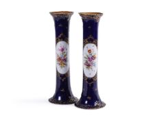 A PAIR OF DRESDEN PORCELAIN BLUE GROUND AND GILT CYLINDRICAL VASES