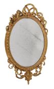 A GILTWOOD AND GESSO OVAL WALL MIRROR