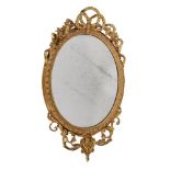 A GILTWOOD AND GESSO OVAL WALL MIRROR