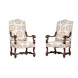 A PAIR OF CARVED WALNUT AND UPHOLSTERED OPEN ARMCHAIRS IN LOUIS XIV STYLE