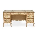 AN ITALIAN CREAM PAINTED AND POLYCHROME DECORATED PEDESTAL DESK