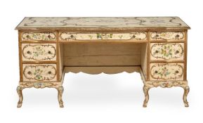 AN ITALIAN CREAM PAINTED AND POLYCHROME DECORATED PEDESTAL DESK