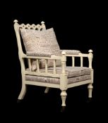 A CREAM PAINTED AND UPHOLSTERED ARMCHAIR, IN VICTORIAN 'GOTHIC REVIVAL' TASTE