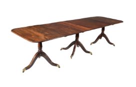 A MAHOGANY TRIPLE PILLAR DINING TABLE