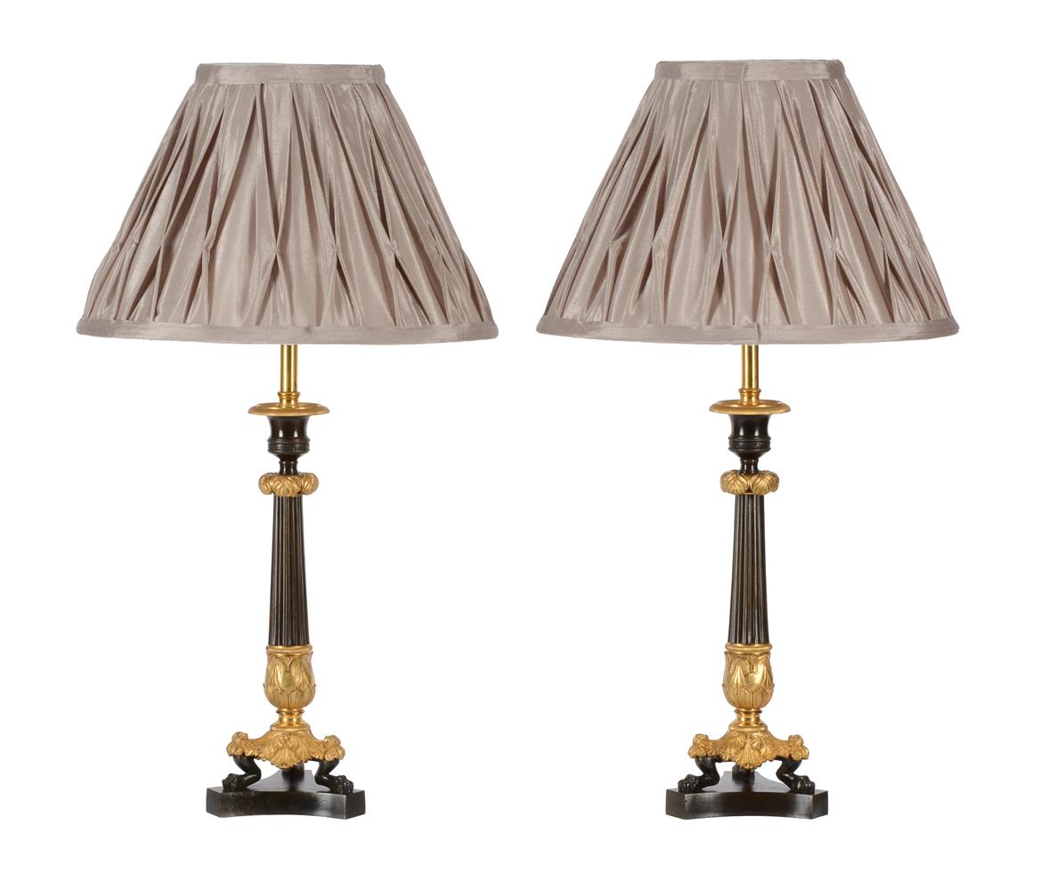 A PAIR OF PARCEL GILT AND PATINATED BRONZE CANDLESTICKS, IN LOUIS PHILIPPE STYLE